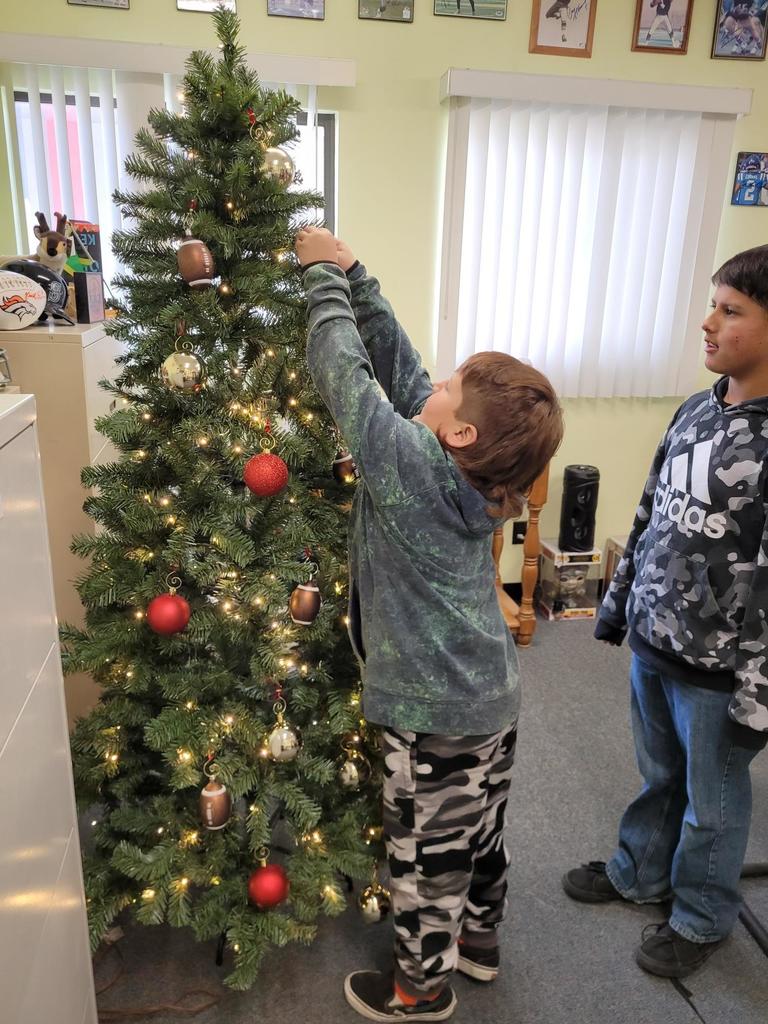 one student hanging ornaments
